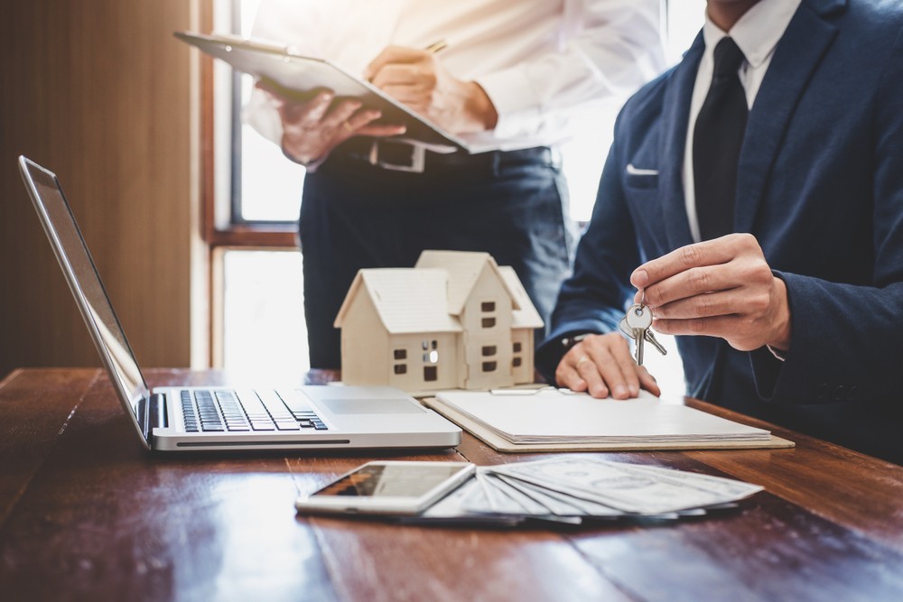 Real estate agent and Sales manager team analysis pricing of rental lease contract of sale purchase agreement Image of a Real estate agent and Sales manager team analysis pricing of rental lease contract of sale purchase agreement