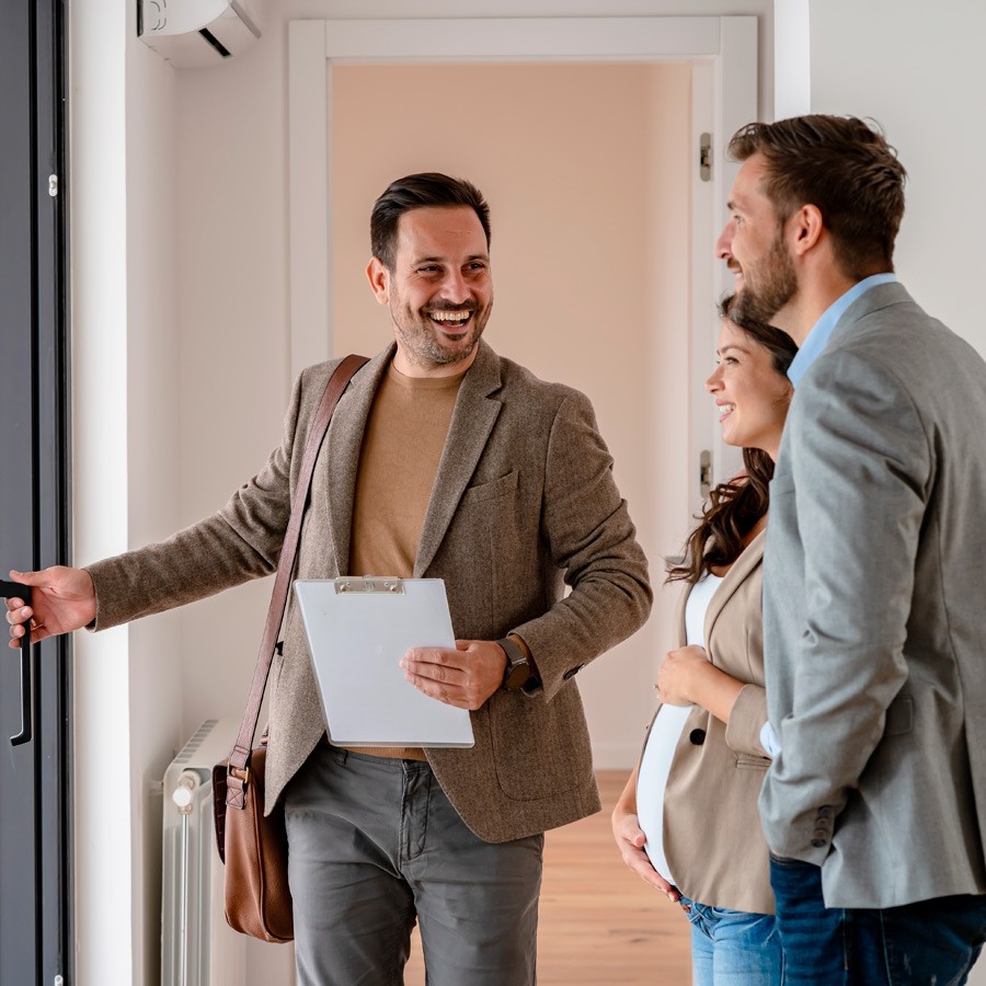 Image of a Real Estate Agent showin a house to a couple